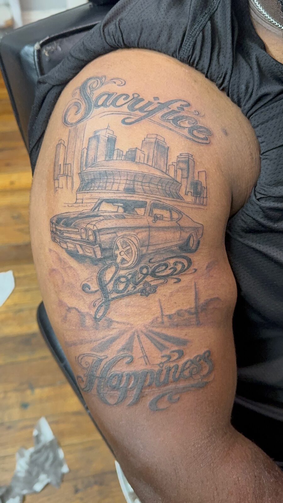 Large custom back tattoo — car, skyline and lettering