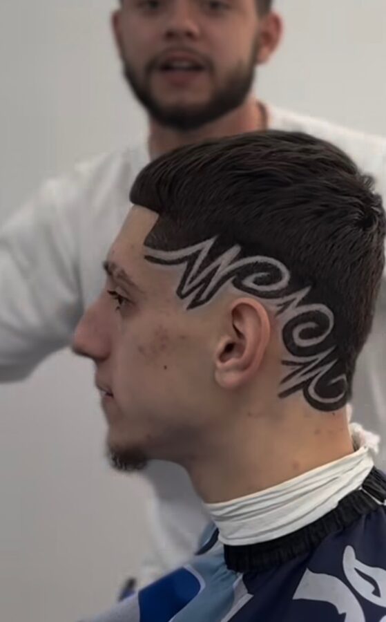 Freehand script design cut into the side of the head